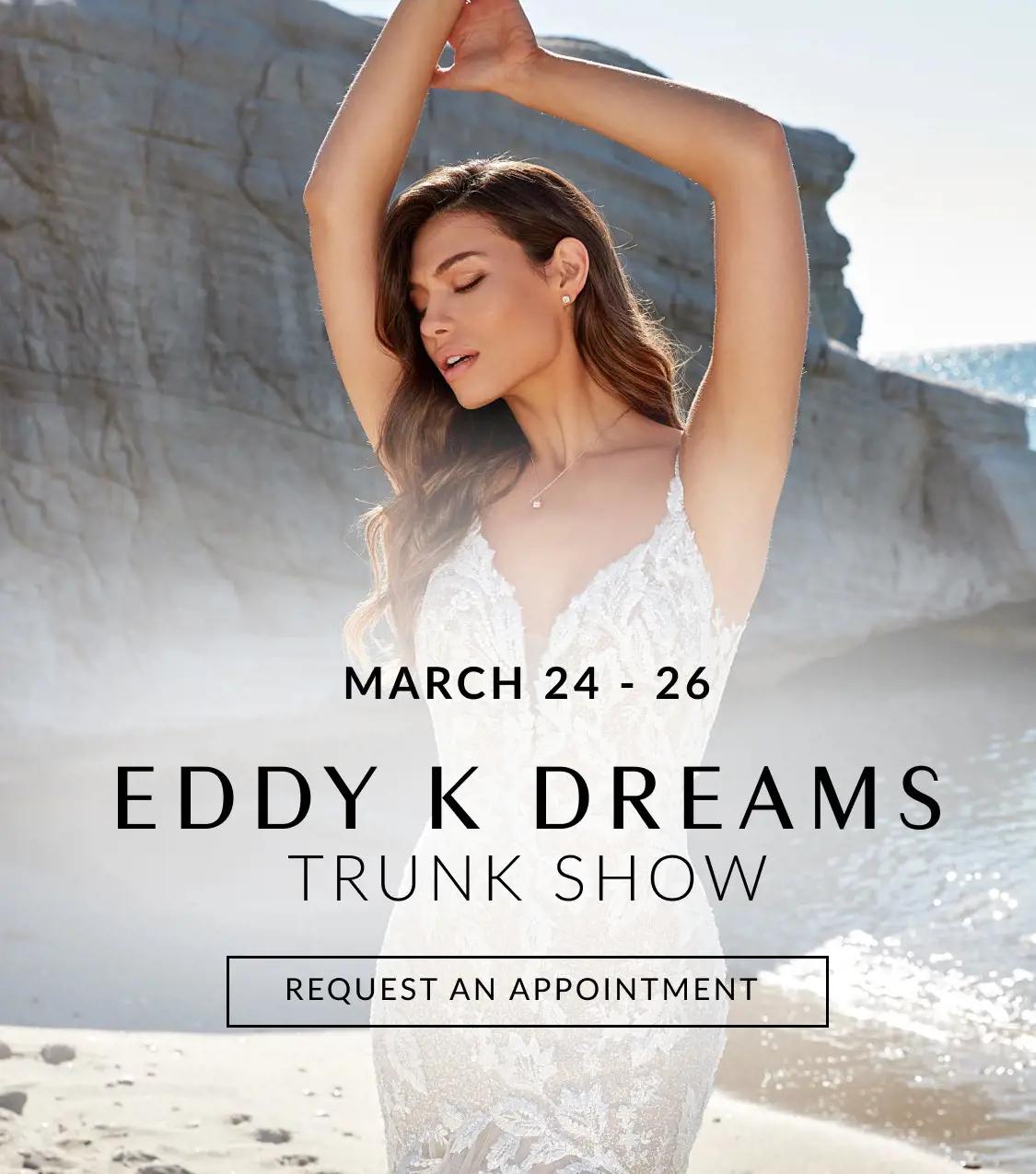 Eddy K trunk show at Allure Bridal Boutique. Model wearing wedding dress on a beach.